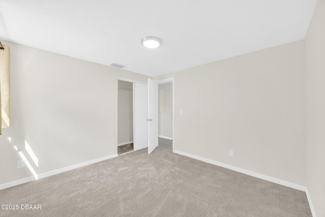 unfurnished bedroom with carpet floors, baseboards, and a closet