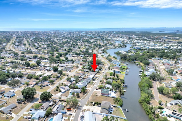 view of property location featuring a nearby body of water and nearby suburban area
