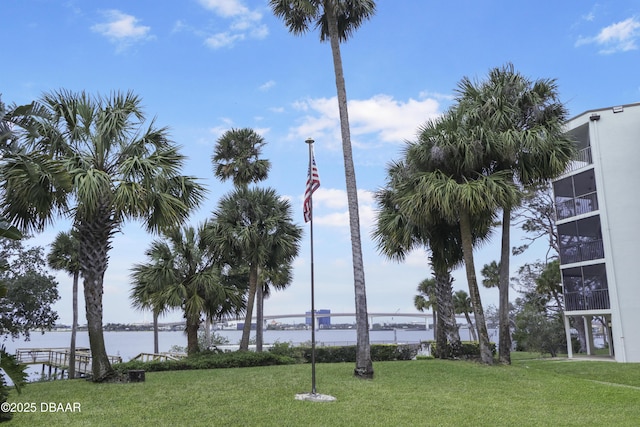 exterior space with a water view and a yard