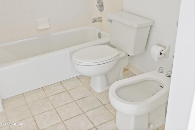 bathroom with toilet, washtub / shower combination, and tile patterned floors