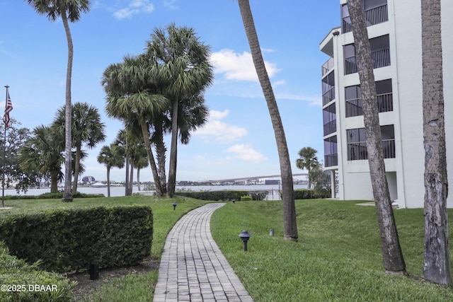 view of home's community with a yard and a water view