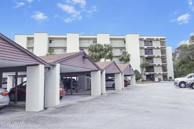 view of building exterior featuring covered parking