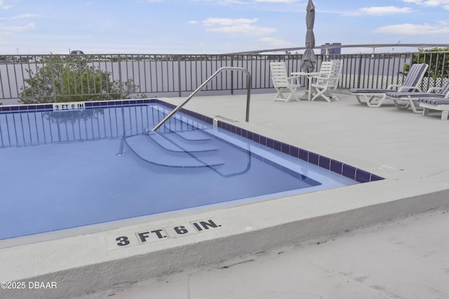 pool featuring a patio and fence