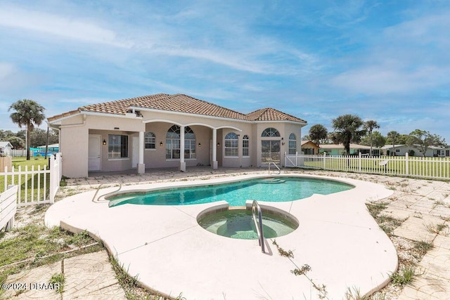 view of pool with a patio area and an in ground hot tub