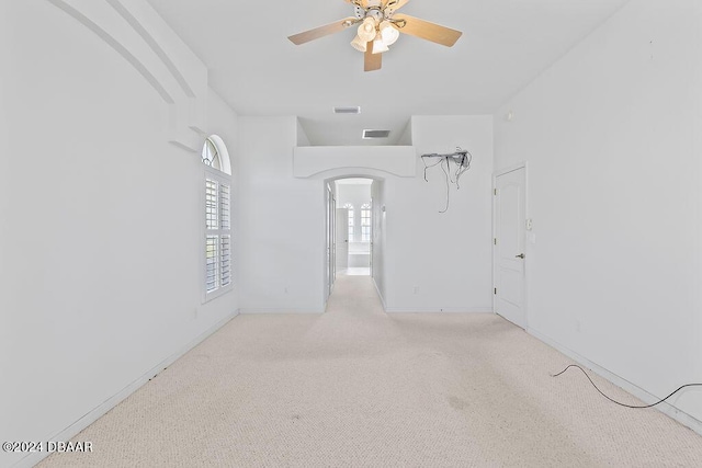 spare room featuring ceiling fan and light carpet