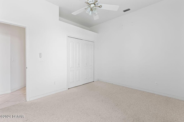 unfurnished bedroom featuring light tile patterned floors, a closet, and ceiling fan