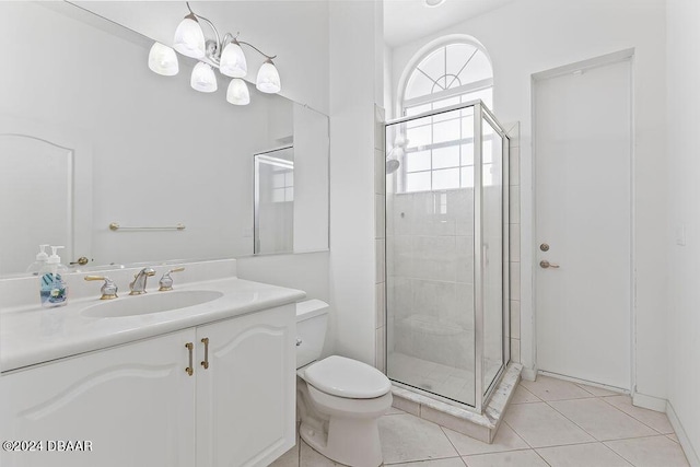 bathroom featuring tile patterned floors, vanity, toilet, and walk in shower