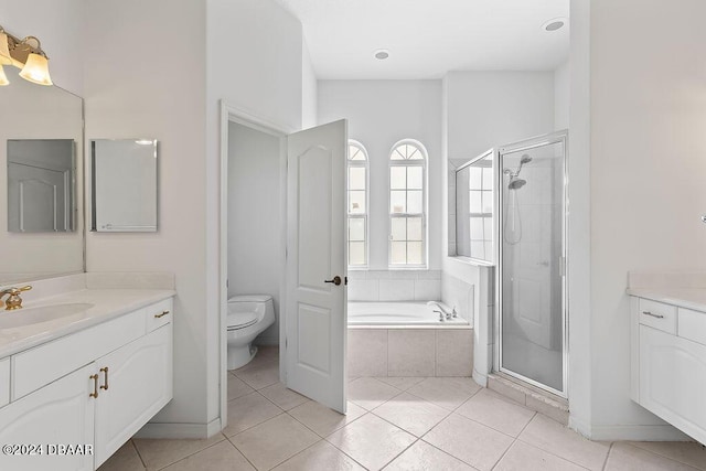 full bathroom featuring tile patterned flooring, vanity, separate shower and tub, and toilet