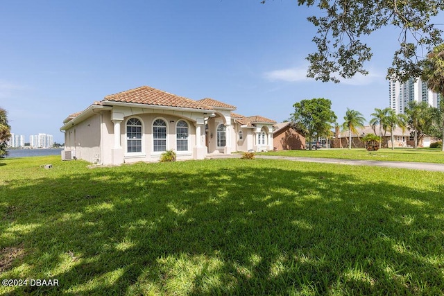 mediterranean / spanish house featuring a front yard