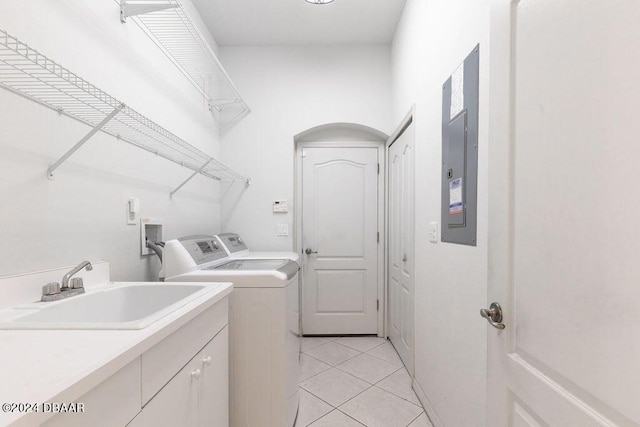 clothes washing area featuring cabinets, sink, washer and dryer, light tile patterned floors, and electric panel