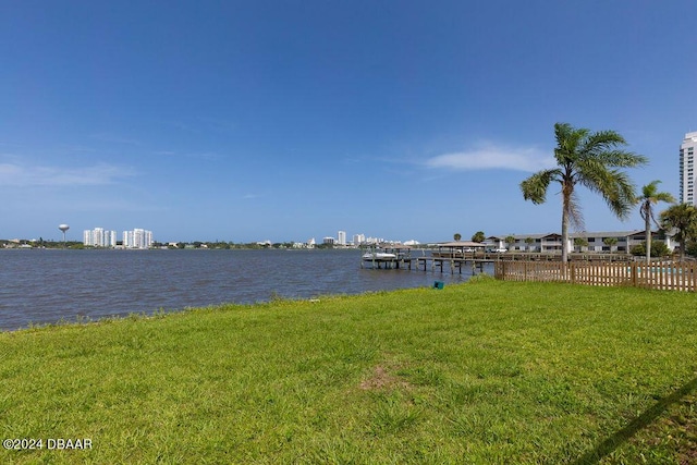 dock area featuring a lawn and a water view