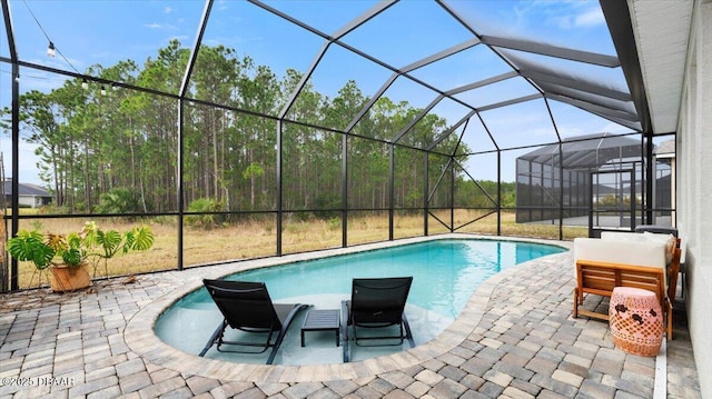 view of pool with a patio and glass enclosure