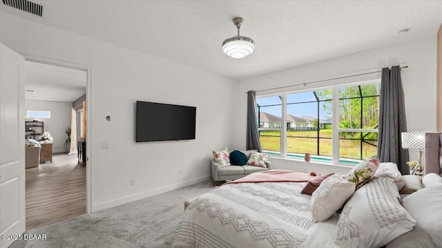 carpeted bedroom featuring a textured ceiling