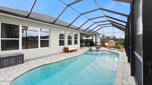 view of swimming pool with a patio and a lanai