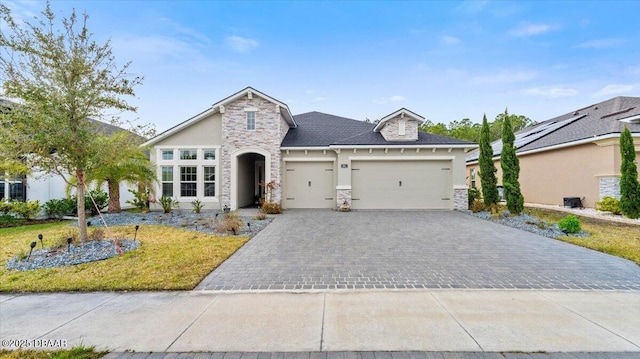 view of front of property with a garage and a front lawn