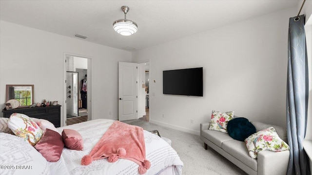 carpeted bedroom featuring a spacious closet