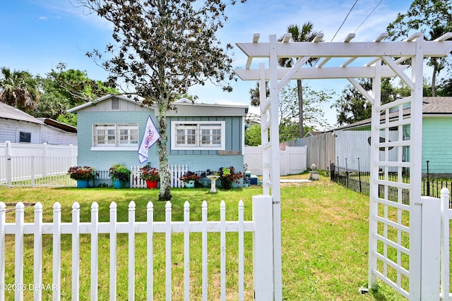 530 Ronnoc Ln, New Smyrna Beach, FL 32168 - view of front of house featuring a fenced backyard and a front lawn