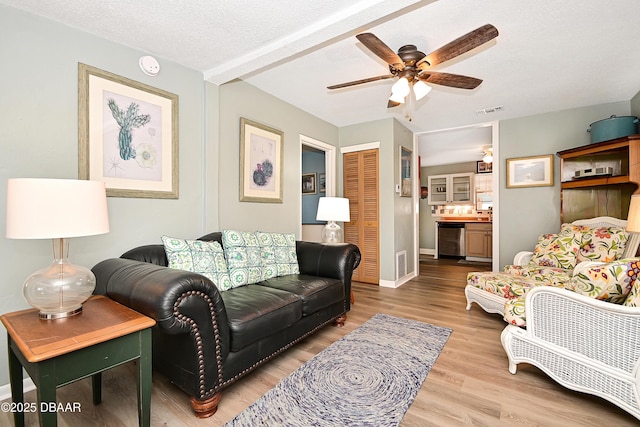 530 Ronnoc Ln, New Smyrna Beach, FL 32168 - living room featuring visible vents, baseboards, a ceiling fan, and wood finished floors