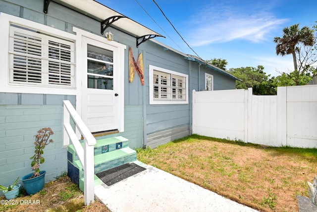530 Ronnoc Ln, New Smyrna Beach, FL 32168 - view of exterior entry featuring fence and a patio area
