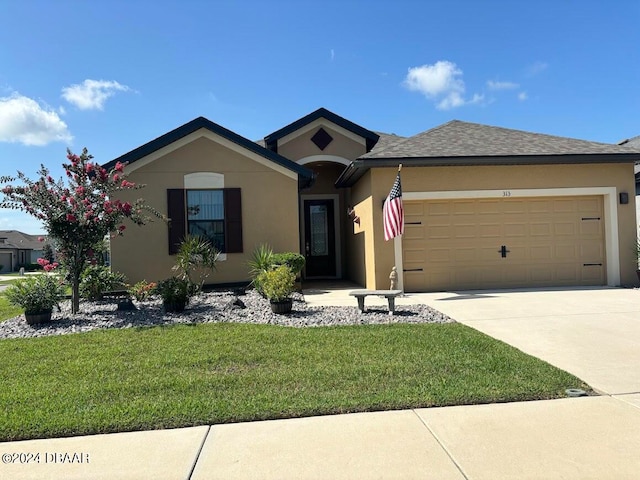 view of front of home with a garage and a front lawn