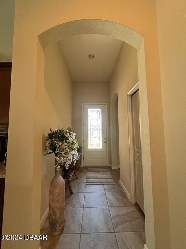 doorway with light tile patterned floors