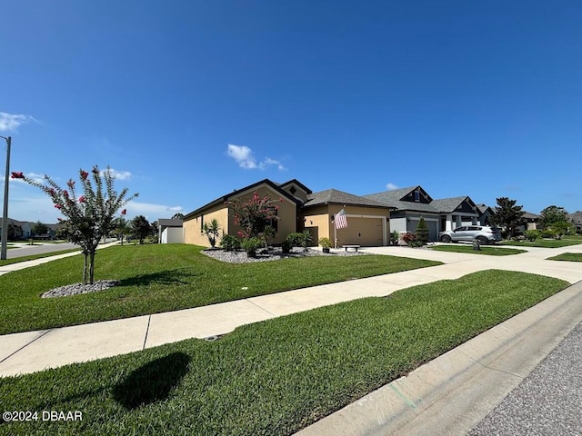 view of front of home with a garage and a front yard