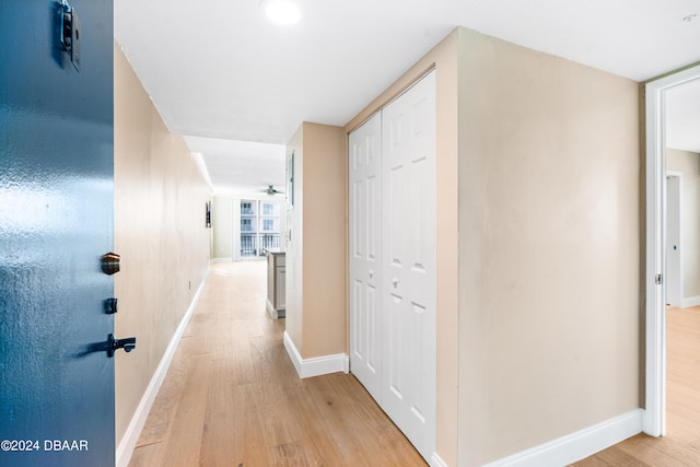 corridor with light hardwood / wood-style floors