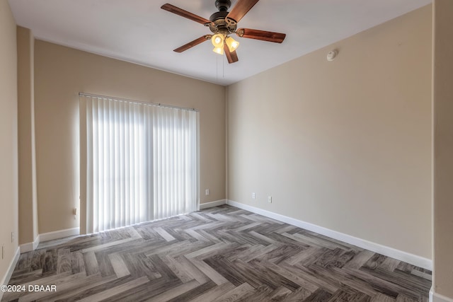 empty room with parquet flooring and ceiling fan