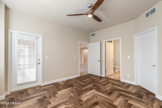 unfurnished bedroom featuring parquet flooring, ceiling fan, and ensuite bathroom