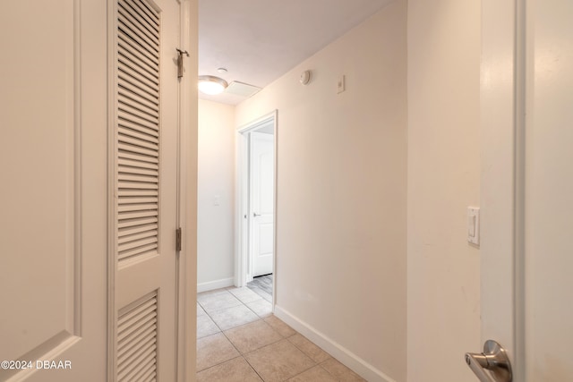 hallway featuring light tile patterned floors