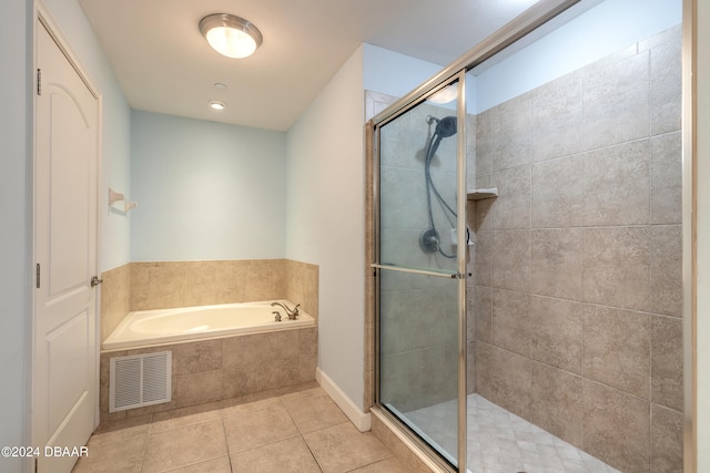 bathroom featuring tile patterned floors and separate shower and tub