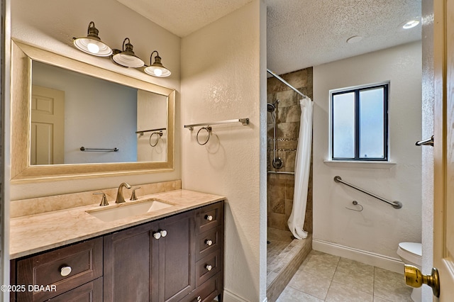 bathroom featuring tile patterned flooring, a textured ceiling, and a shower stall