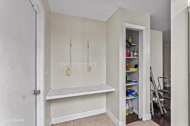 interior space featuring tile patterned flooring and baseboards