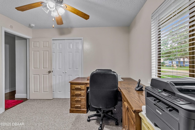 office space featuring a textured ceiling, ceiling fan, and carpet flooring