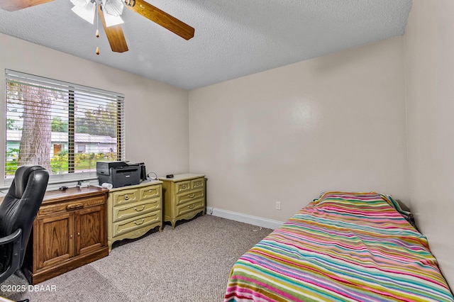 bedroom with ceiling fan, baseboards, a textured ceiling, and light colored carpet