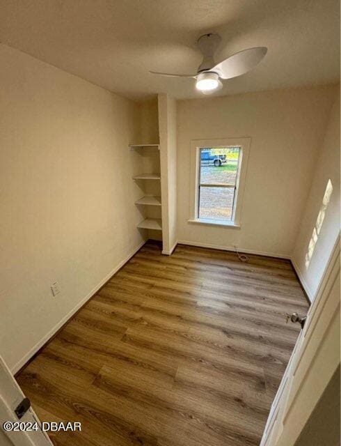 interior space with a ceiling fan and wood finished floors