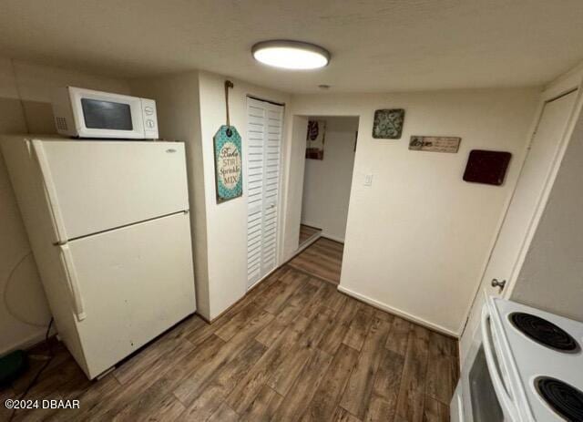 kitchen featuring white appliances and wood finished floors