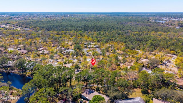 aerial view featuring a view of trees and a water view