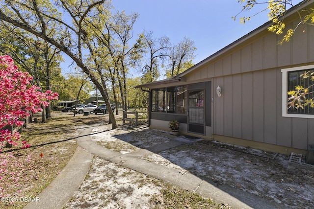 view of property exterior featuring a sunroom