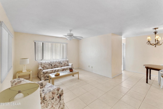 living room featuring light tile patterned floors and ceiling fan with notable chandelier