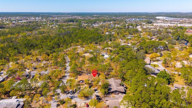 drone / aerial view featuring a wooded view