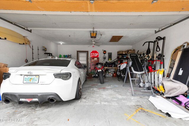 garage featuring ceiling fan and a garage door opener