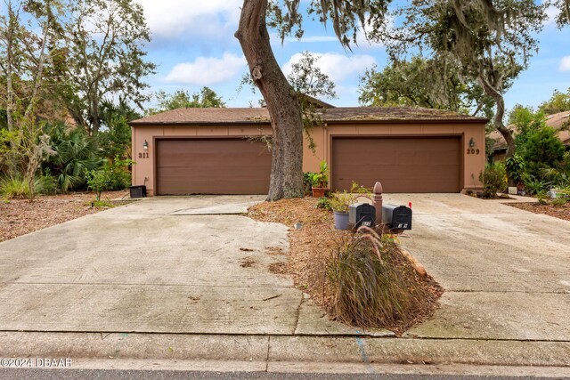 ranch-style home featuring a garage