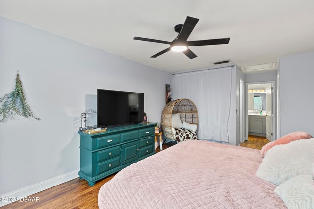 bedroom featuring ceiling fan, connected bathroom, and light wood-type flooring