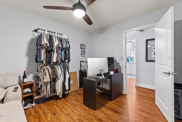 office with hardwood / wood-style floors and ceiling fan