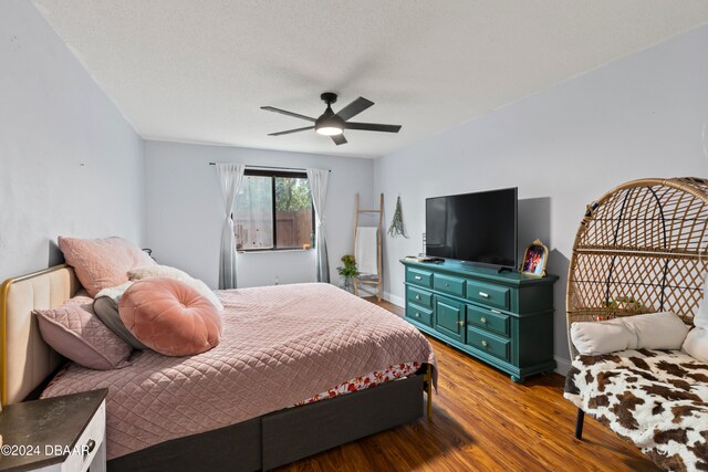 bedroom featuring a textured ceiling, light wood-type flooring, and ceiling fan