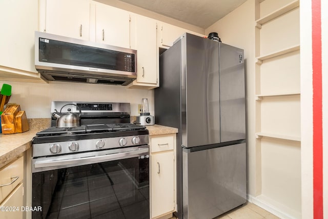 kitchen featuring light tile patterned flooring and stainless steel appliances