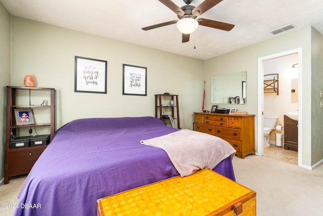 carpeted bedroom featuring ensuite bath and ceiling fan