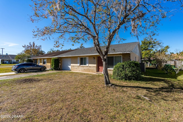 ranch-style house featuring a garage and a front lawn