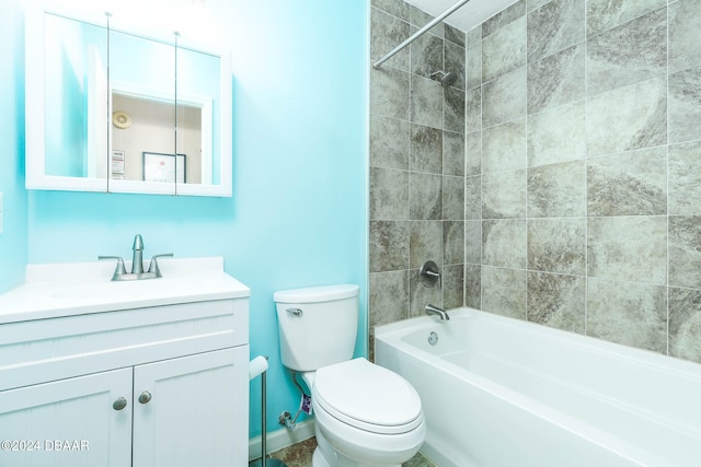 full bathroom featuring vanity, tiled shower / bath combo, and toilet